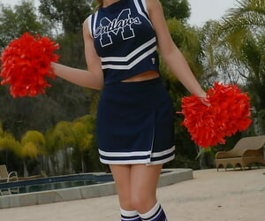 Teenage cheerleader Dani Daniels pulls up her mini-skirt..