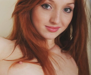 Pallid Russian redhead wears a crazy smile and nothing..
