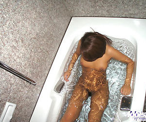 Attractive asian slut takes bath..