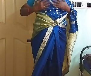 desi north indian horny cheating wife vanitha wearing blue colour saree showing big boobs and shaved pussy press hard..