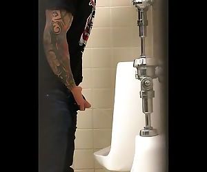 Tattooed Pisser with Nice Cock Notices His Voyeur Spying on Him.