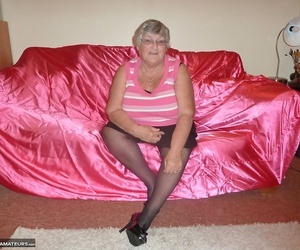 Obsese grandmother holds her big rolls while disrobing to..