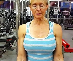 old woman with large breasts and muscular arms trains biceps 2