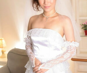 Brunette Asian bride Yuri Manaka unveils her tiny tits and rubs her bush