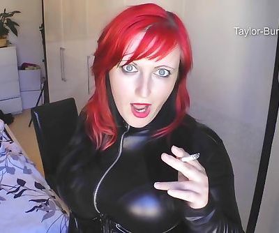 redhead smoking in leather catsuit