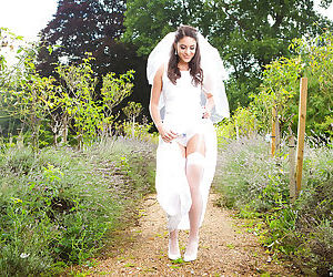 Newly married bride Carolina Abril posing outdoors in wedding dress