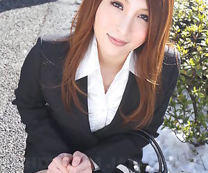 Hot redhead Japanese girl in suit poses to show her..