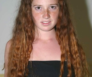 Young looking girl with curly red..