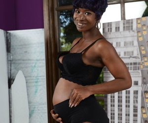 Pregnant black teen Tiana Grey cups her swollen tits..