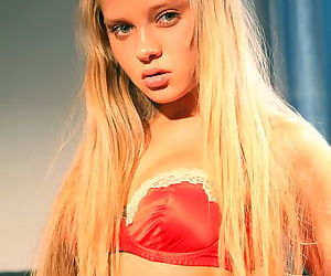 Blonde teen beauty in a satin bra..