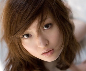Japanese teenage Maiko Kazano wets her great tits and..