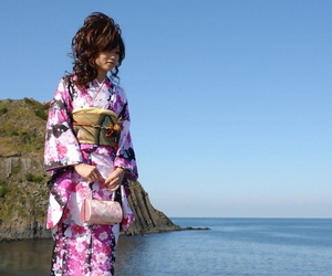 Asian model Chiaki strolls along the beach and surrounding..