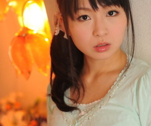 Fully clad Japanese girl Nozomi Hazuki holds her face rock..