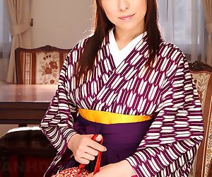 Japanese woman Himeki Kaede prepares to shed her kimono to..