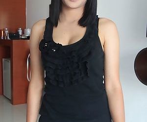 Cute Asian Jang displays her natural tits while wearing..