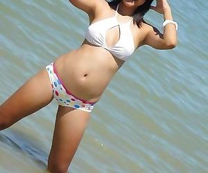 Cute little thai amateur febe poses at the beach and..