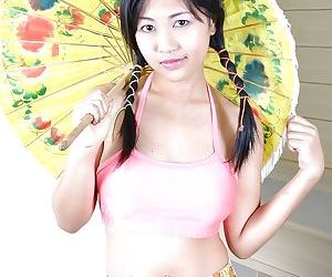 Busty asian babe with pigtails stripping and playing with..