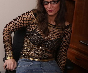 Playful mature girl in glasses getting rid of her clothes