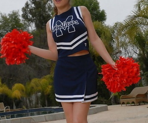 Teenage cheerleader Dani Daniels pulls up her micro-skirt..