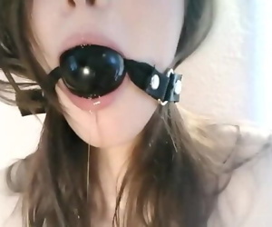 Bound girl with ball gag gets messy
