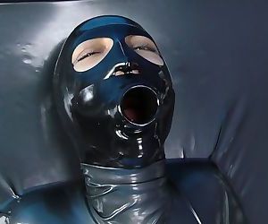 Girl in latex catsuit enters vacbed , then gets masked and gagged