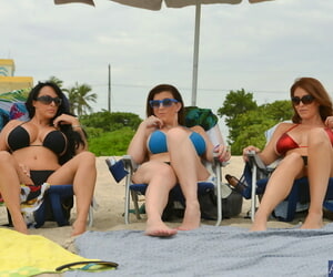 Three busty beach babes pull aside bikini tops to flaunt..